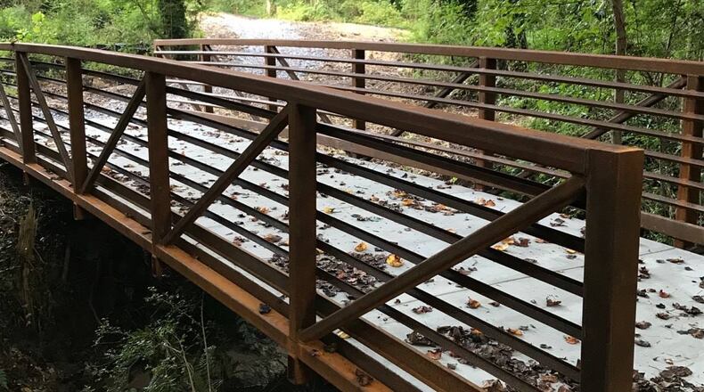 The new Hunter-Walker Trail in Norcross features a paved path, pedestrian bridge and public art by artist Dr. Angelika Domschke honoring the city’s Bee City designation. (Courtesy City of Norcross)