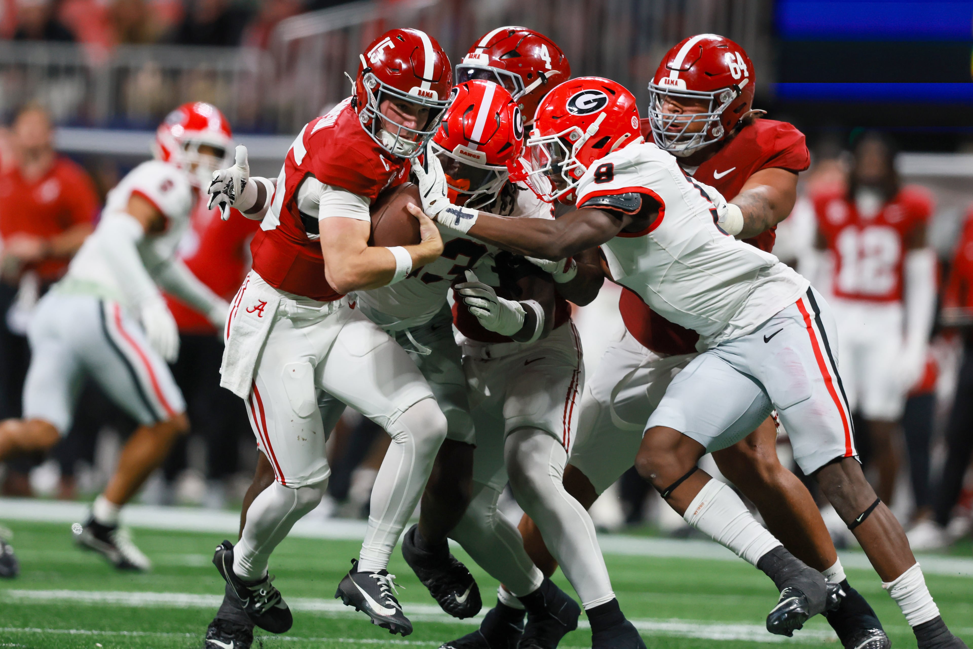Georgia linebackers Chris Cole (9) and Quintavius Johnson (33) tackle Alabama quarterback Ty Simpson (15) during the fourth quarter of the SEC Championship game at Mercedes-Benz Stadium, Saturday, Dec. 6, 2025, in Atlanta. (Jason Getz / AJC)