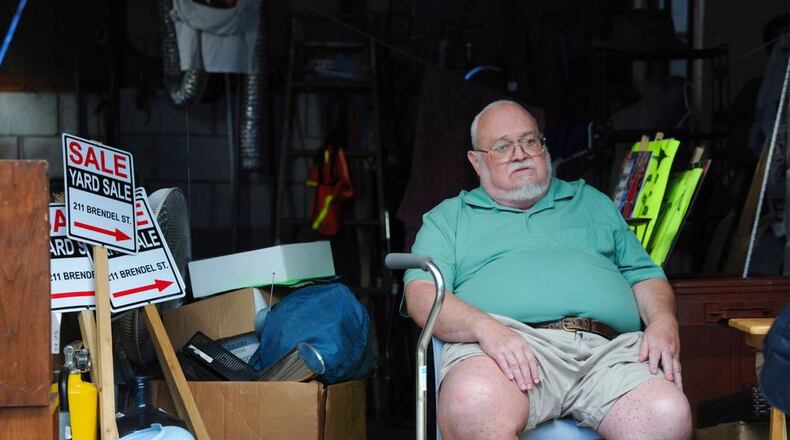 Willie Davis, a U.S. Navy veteran who is dying from cancer, sits in his garage among many of his belongings, which he's trying to sell to help pay for his own funeral, Wednesday, Sept. 26, 2018, in Johnstown, Pa. (John Rucosky/Tribune-Democrat via AP)