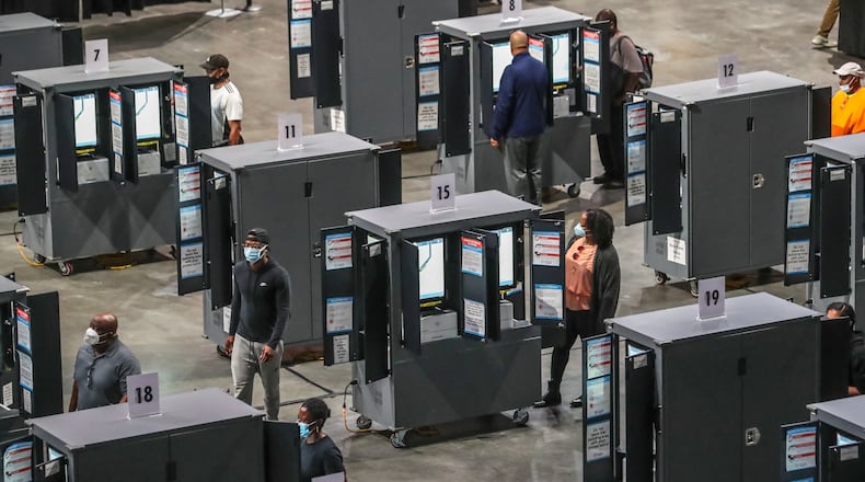 Voters cast ballots on Georgia's voting machines at State Farm Arena in downtown Atlanta in October 2020. (John Spink / John.Spink@ajc.com)