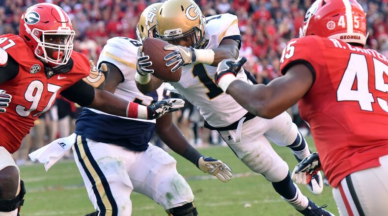 Georgia Tech running back Qua Searcy (1) leaps over for a game-winning touchdown at Sanford Stadium on Saturday, November 26, 2016. Georgia Tech won 28-27 over Georgia. HYOSUB SHIN / HSHIN@AJC.COM
