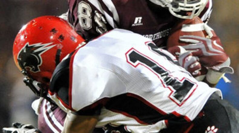 Morehouse Derrick Hector (85) gets hit by Clark Atlanta Brandon Wilkerson (19) after he made a catch in the first half at B.T. Harvey Stadium in Morehouse College in this 2011 file photo.