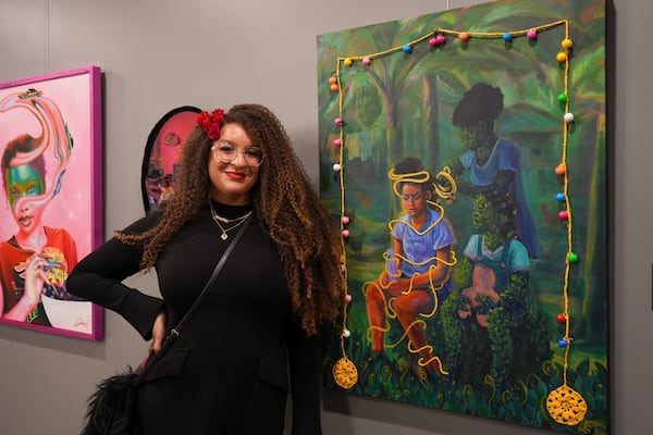 Metro Atlanta artist Reinilda Blair in front of her mixed media work in the CBrooks Gallery exhibit "Journey of a Black Girl" through March 28. (Courtesy of Djele Productions)