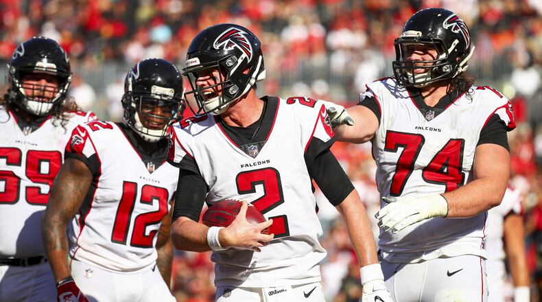 Falcons quarterback Matt Ryan celebrates with offensive tackle Ty Sambrailo (74) after catching a touchdown pass from wide receiver Mohamed Sanu in the third quarter Dec. 30, 2018, at Raymond James Stadium in Tampa, Fla.