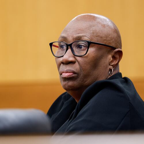 Janet Williams watches a witness walk in during her murder trial at the Fulton County Courthouse in Atlanta on Tuesday. Williams is accused in the stabbing death of 90-year-old Chun-ki Kim, who lived in the Buckhead apartment complex where Williams worked as a security guard. (Arvin Temkar/AJC)