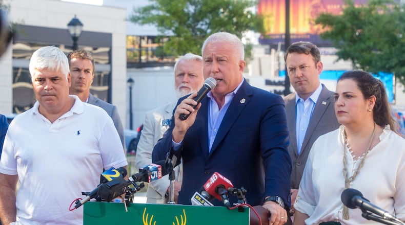 Buckhead City supporters, including Bill White, at podium, who is the Buckhead City Committee Chairman and CEO as well as area senators, local residents and some opposed to the creation of a new city gather for a press conference at Loudermilk Park on Wednesday, Sept 29, 2021. The group announced that during the upcoming special legislative session the bill will be discussed. Several state senators signed the bill onsite, illustrating support in the state Senate. (Jenni Girtman for The Atlanta Journal-Constitution)