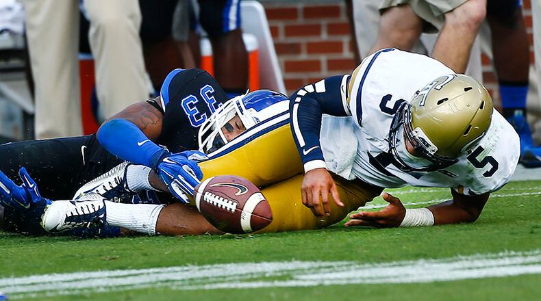 Georgia Tech quarterback Justin Thomas (5) fumbles the ball as he is tackled by Duke safety Deondre Singleton in Saturday's 31-25 loss to Duke.