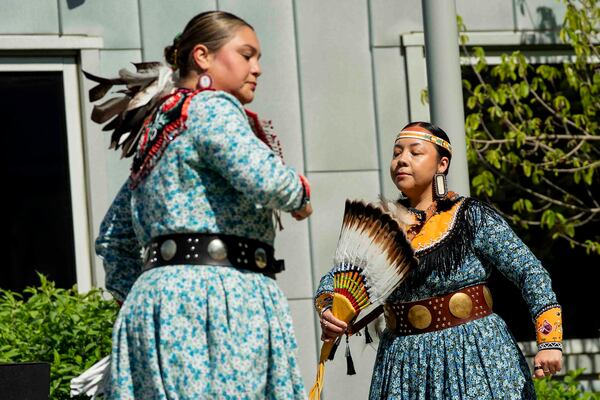 Nicole Hill, left, and Aryien Stevens of the Gëjohgwa' dancers perform before New York Gov. Kathy Hochul's formal apology to the Seneca Nation for New York State's role in operating the Thomas Indian School, Tuesday, May 20, 2025, outside the William Seneca Administration Building in Irving, N.Y. (Libby March/The Buffalo News via AP)
