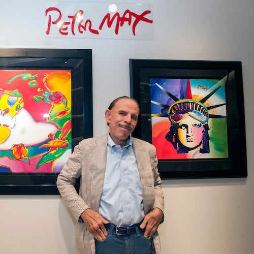 FILE - Artist Peter Max poses for a photo during his retrospective with the Road Show Company exhibit, Sept. 6, 2014, in Northbrook Court mall in Northbrook, Ill. (Photo by Barry Brecheisen/Invision/AP, File)