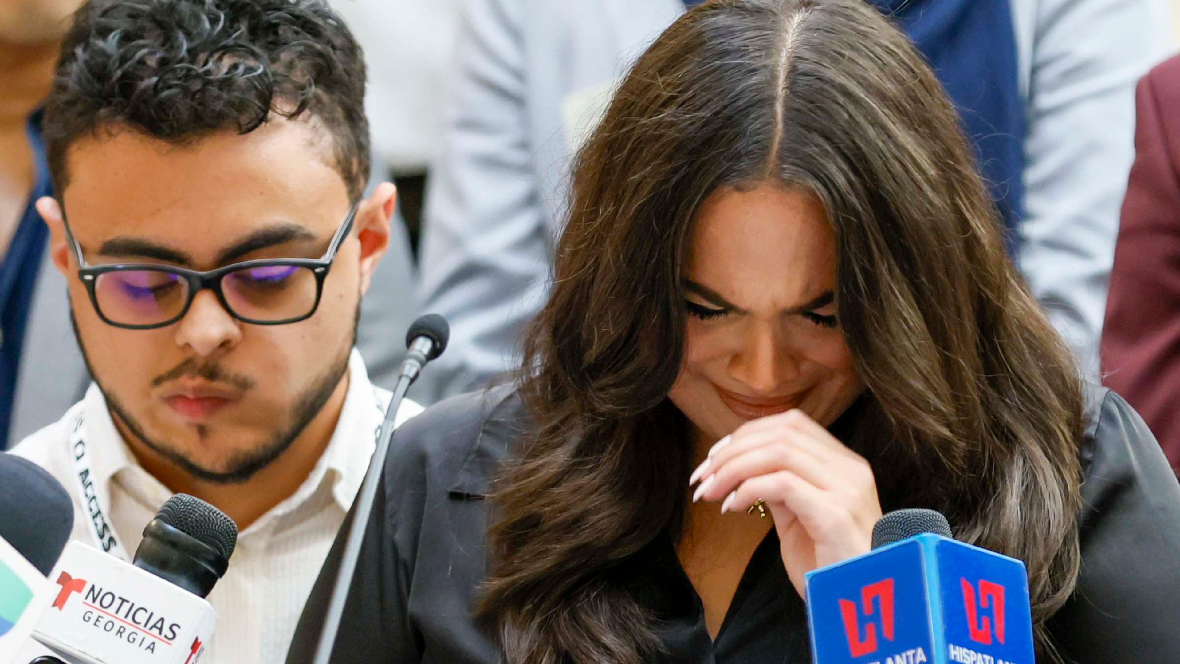 “Since he’s been detained, our family has felt an emptiness that we cannot begin to fill. My mom is exhausted. My brothers and I feel like we’re stuck in a nightmare,” the journalist's daughter, Katherine Guevara, said at a news conference Tuesday, with her brother Oscar Guevara. (Miguel Martinez/AJC)