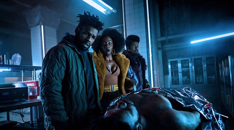 From left, John Boyega, Teyonah Parris and Jamie Foxx in "They Cloned Tyrone." (Parrish Lewis/Netflix/TNS)