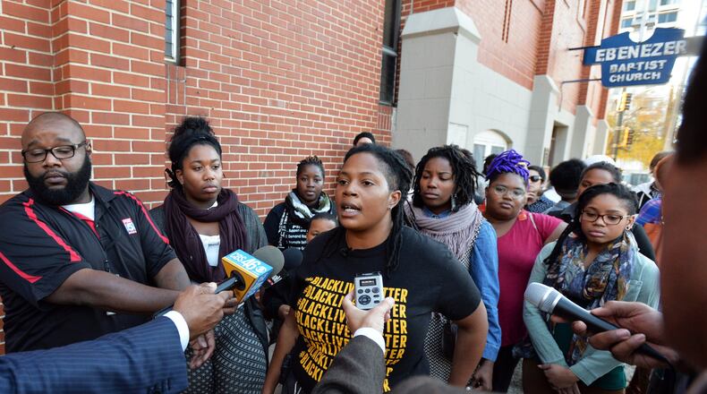 Atlanta Black Lives Matter activist and organizer Mary Hooks (center) speaks to the media on Nov. 24, 2014, outside Ebenezer Baptist Church in Atlanta, where she announced a peaceful rally at Underground Atlanta in response to developments in Ferguson, Mo., following a police officer’s fatal shooting of an unarmed black man. (BRANT SANDERLIN / bsanderlin@ajc.com)