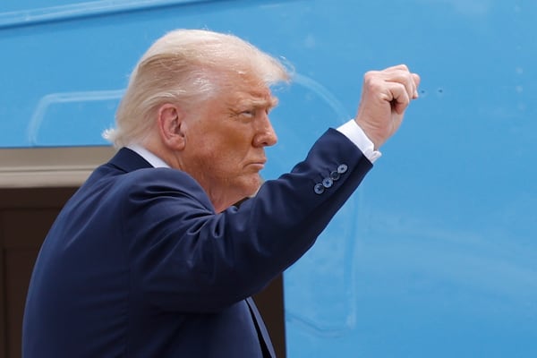 President Donald Trump gestures from the stairs of Air Force One as he boards upon his arrival at Joint Base Andrews, Md., Tuesday, July 15, 2025. (AP Photo/Luis M. Alvarez