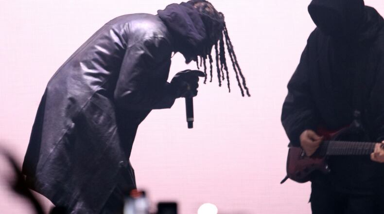 Atlanta rapper Playboi Carti (left) has worked with Interscope Records, a label under Universal Music Group, for nearly 10 years. (Robb Cohen for the AJC 2021)