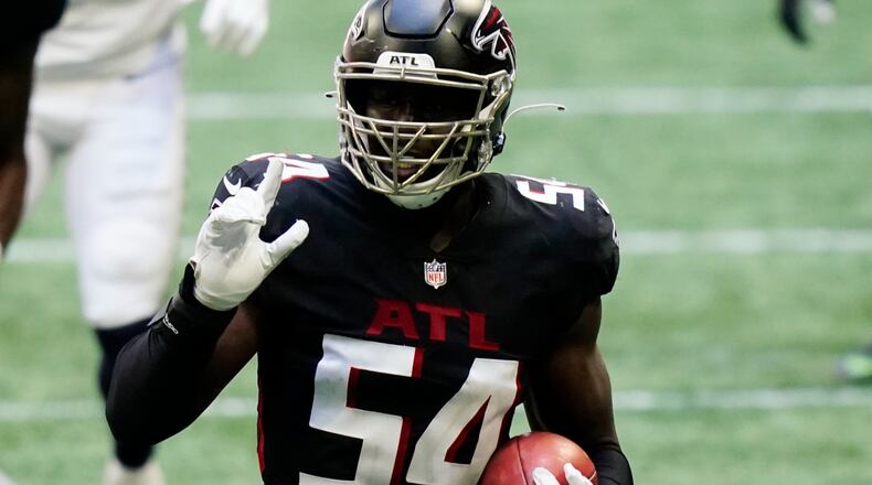 Atlanta Falcons linebacker Foye Oluokun (54) picks up an on-side kick against the Seattle Seahawks during the second half Sunday, Sept. 13, 2020, in Atlanta. (Brynn Anderson/AP)