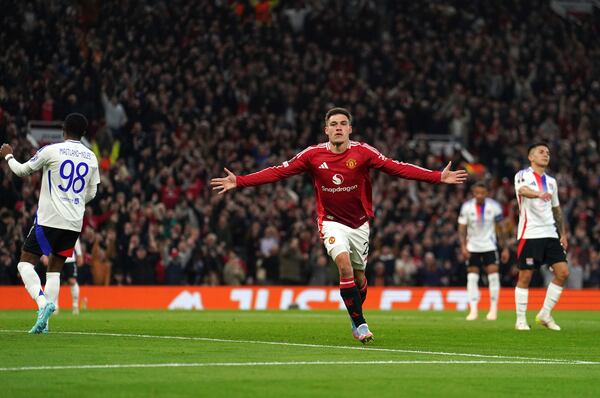 Manchester United's Manuel Ugarte celebrates after scoring his side's opening goal during the Europa League quarter final second leg soccer match between Manchester United and Olympique Lyon in Manchester, England, Thursday, April 17, 2025. (Martin Rickett/PA via AP)