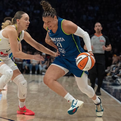 Minnesota Lynx guard Kayla McBride (21) drives to the basket on Dallas Wings guard Paige Bueckers in the first half of a basketball game, Sunday Aug. 9, 2026 in Minneapolis. (Jerry Holt/Minnesota Star Tribune via AP)