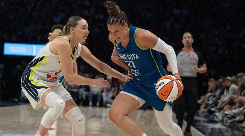 Minnesota Lynx guard Kayla McBride (21) drives to the basket on Dallas Wings guard Paige Bueckers in the first half of a basketball game, Sunday Aug. 9, 2026 in Minneapolis. (Jerry Holt/Minnesota Star Tribune via AP)