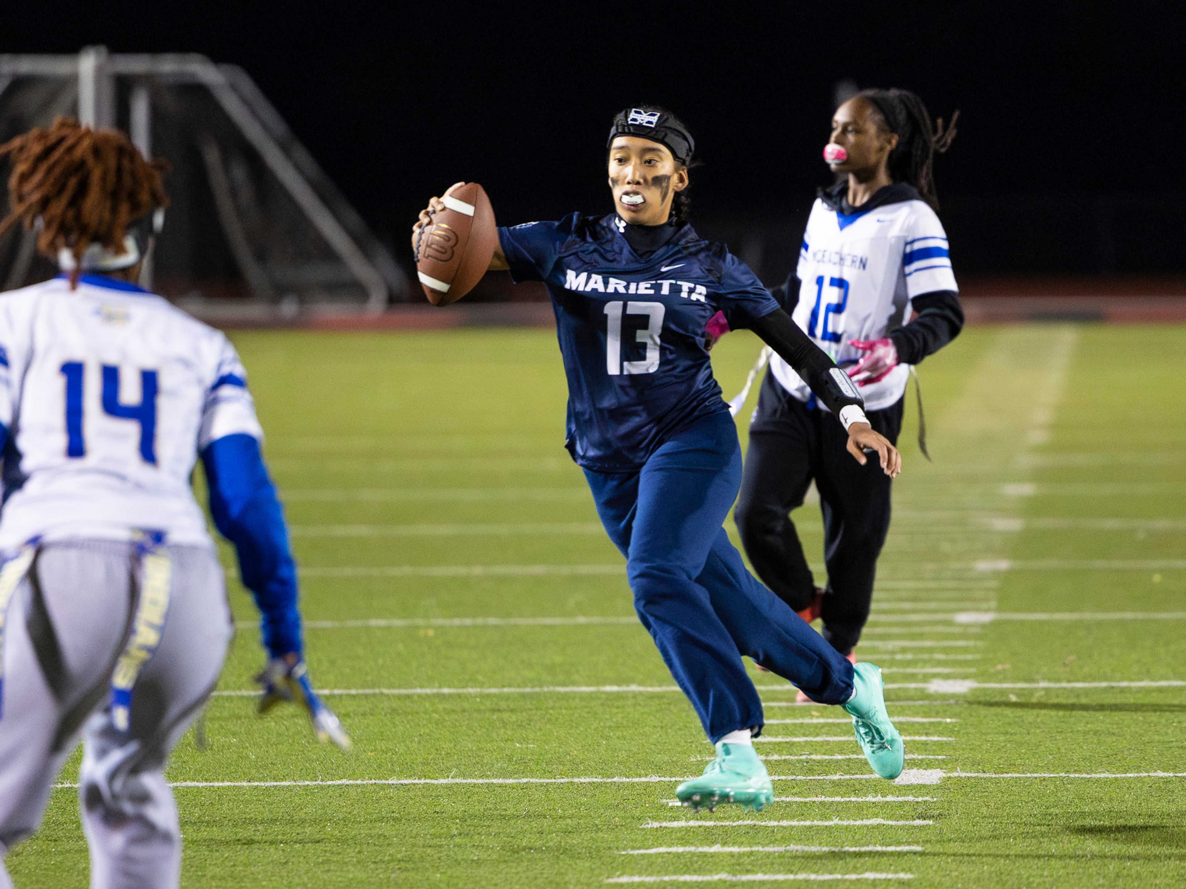 Marietta's Kaylee Wang (13) runs with the ball in a flag football game against McEachern at Osborne High School in Marietta, GA on Monday, November 17th, 2025. (Oscar Guevara Saenz for the AJC)