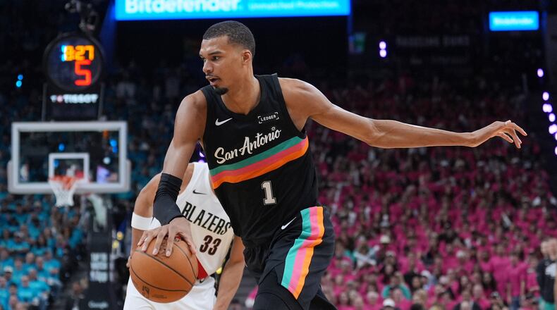 San Antonio Spurs forward Victor Wembanyama (1) drives past Portland Trail Blazers forward Toumani Camara (33) during the second half in Game 1 of a first-round NBA playoffs basketball series in San Antonio, Sunday, April 19, 2026. (AP Photo/Eric Gay)