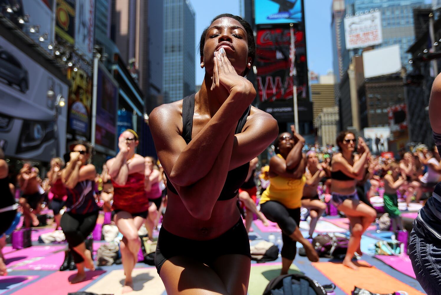 Enthusiasts perform yoga in Times Square to mark summer solstice, June 21, 2013