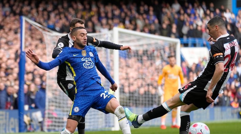 Chelsea's Hakim Ziyech, left, and Newcastle's Miguel Almiron vie for the ball during the English Premier League soccer match between Chelsea and Newcastle United at Stamford Bridge stadium in London, Sunday, March 13, 2022. (AP Photo/Kirsty Wigglesworth)