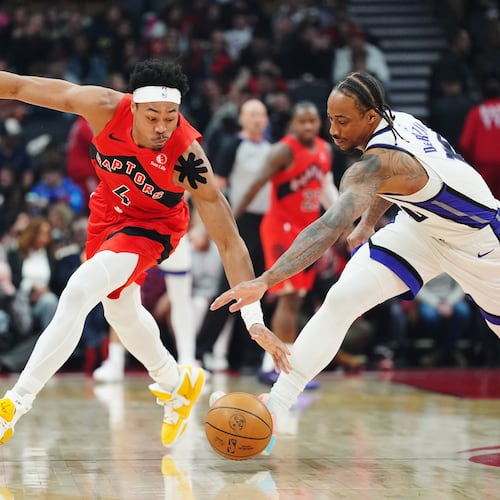 Toronto Raptors' Scottie Barnes (4) and Sacramento Kings' DeMar DeRozan (10) battle for the ball during the first half of an NBA basketball game in Toronto, Wednesday, April 1, 2026. (Frank Gunn/The Canadian Press via AP)