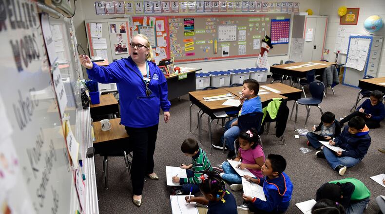 December 14, 2016, Norcross - Audrey Smith, 25, a first-year, first grade teacher at Baldwin Elementary School, draws a picture on the whiteboard for a class exercise in Norcross, Georgia. Gwinnett has approved a new teacher compensation plan that administrators hope will recruit and retain more teachers. (DAVID BARNES / DAVID.BARNES@AJC.COM)
