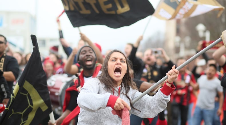 Andrea Bustamante of Atlanta part of Terminus Fan Club cheers the arrival of the Atlanta United Bus. (Miguel Martinez)