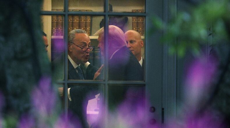 Senate Minority Leader Chuck Schumer (D-N.Y.), left, makes a point to President Donald Trump in the Oval Office on September 6, 2017. (Photo by Alex Wong/Getty Images)