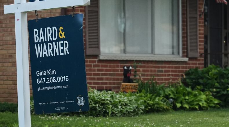 For sale sign is seen outside of a home in Wheeling, Ill., Monday, June 8, 2026. (AP Photo/Nam Y. Huh)