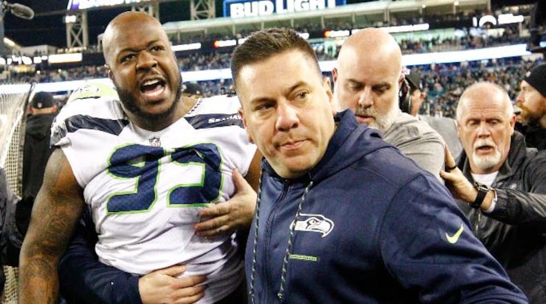 Members of the Seattle Seahawks staff escort Seattle Seahawks defensive tackle Quinton Jefferson (99) from the field after he got into a shouting match with fans, when objects were thrown at him, in the closing moments of an NFL football game against the Jacksonville Jaguars, Sunday, Dec. 10, 2017, in Jacksonville, Fla. Jacksonville won 30-24.(AP Photo/Stephen B. Morton)
