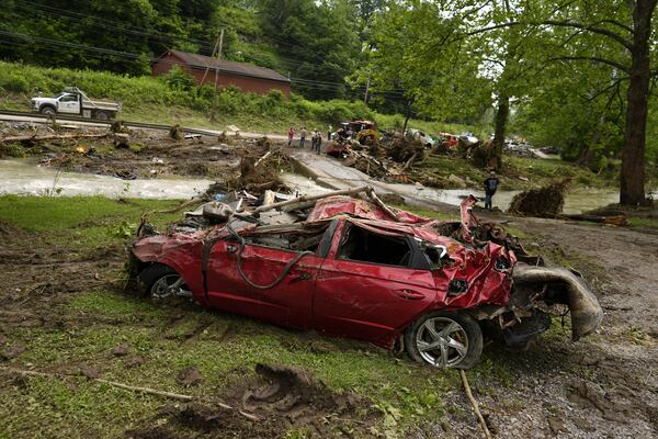A damaged vehicle sits in flood debris, Monday, June 16, 2025, in Valley Grove, W.Va. (AP Photo/Carolyn Kaster)