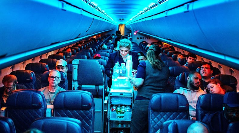 Flight attendants serve refreshments on a Delta Air Lines flight from Hartsfield-Jackson International Airport on Aug. 1, 2022, in Atlanta. (Kent Nishimura/Los Angeles Times/TNS)