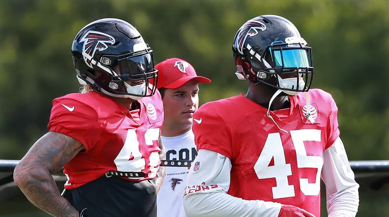 August 7, 2018 Flowery Branch: Atlanta Falcons linebackers Duke Riley (left) and Deion Jones watch from the sidelines between defensive series at NFL football training camp practice on Tuesday, August 7, 2018, in Flowery Branch. Curtis Compton/ccompton@ajc.com