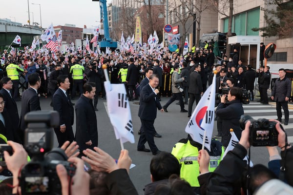 FILE - Impeached South Korean President Yoon Suk Yeol, center, greets his supporters upon his arrival outside of presidential residence in Seoul, South Korea, on March 8, 2025. (Kim In-chul/Yonhap via AP)