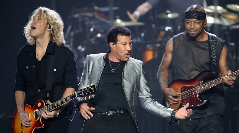 Lionel Richie, along with guitarist Ben Mauro and bassist Ethan Farmer, put some zip into "Running With the Night." Photo: Photo: Robb Cohen Photography & Video /RobbsPhotos.com