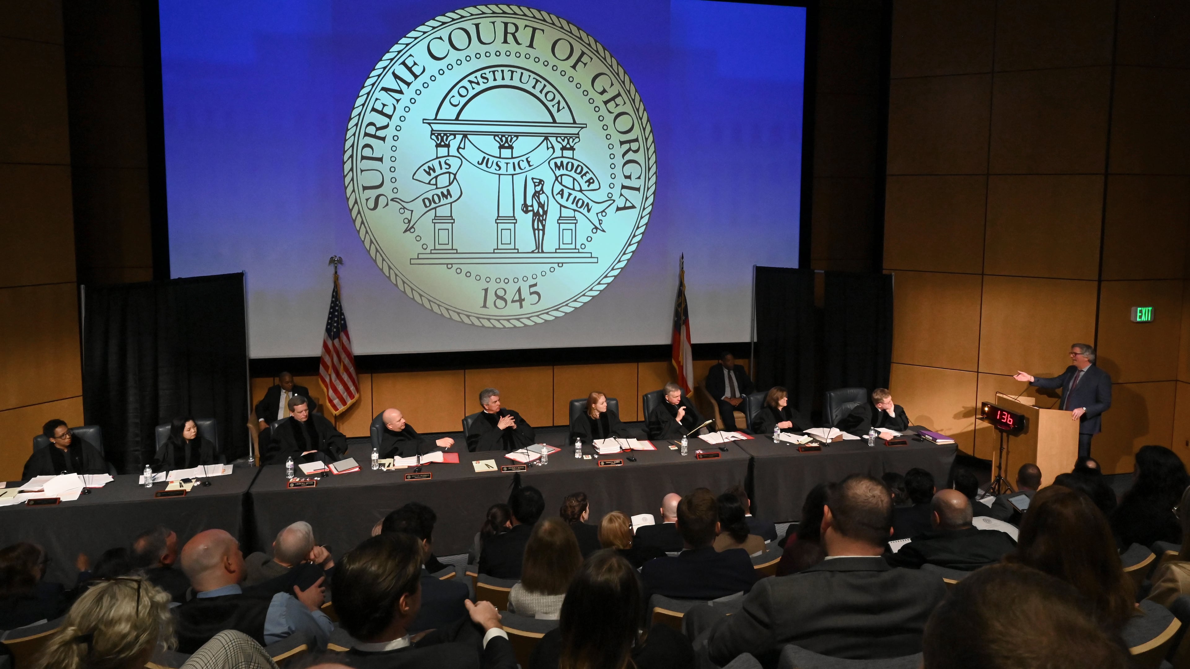 Attorney Chris Anulewicz (at lectern) presents oral arguments in an appeal of State Election Board rules at a Georgia Supreme Court off-site special session in March. (Hyosub Shin/AJC)