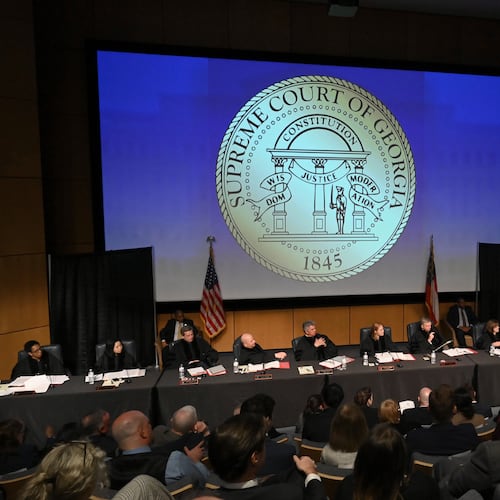 Attorney Chris Anulewicz (at lectern) presents oral arguments in an appeal of State Election Board rules at a Georgia Supreme Court off-site special session in March. (Hyosub Shin/AJC)