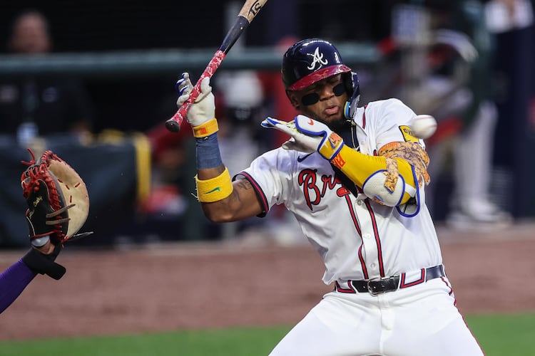Atlanta Braves' Ronald Acuña Jr. tries to avoid a pitch in the first inning of a baseball game against the Arizona Diamondbacks, Wednesday, June 4, 2025, in Atlanta. (AP Photo/Colin Hubbard)