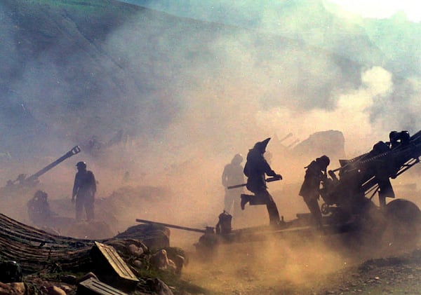 FILE - Indian artillery guns are engulfed in smoke in Dras, some 155 kilometers (96 miles) north of Srinagar, India, as Indian troops fight Pakistani intruders in the disputed Kashmir on July 10, 1999. (AP Photo/Aijaz Rahi, File)