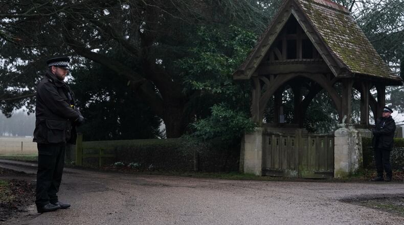Police officers guard the entrance to the Sandringham Royal Estate in Sandringham, England, Thursday, Feb. 19, 2026 after Andrew Mountbatten-Windsor was arrested by British police on suspicion of misconduct in public office. (AP Photo/Alastair Grant)