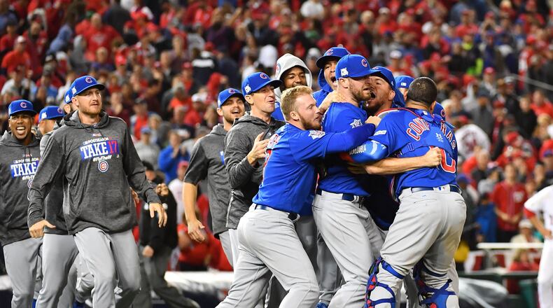 The Cubs celebrate after defeating the Nationals in Game 5.