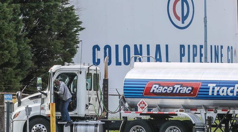 Gasoline tankers pass by the Colonial Pipeline storage tanks in Austell, Ga., on Monday, May 10, 2021, as they enter the Marathon Powder Springs Terminal.  (John Spink/The Atlanta Journal-Constitution/TNS)