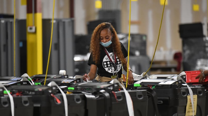 Fulton County election workers prepare before all voting machines come back to the warehouse at Fulton County Election Preparation Center on Tuesday, May 24, 2022. (Hyosub Shin / Hyosub.Shin@ajc.com)