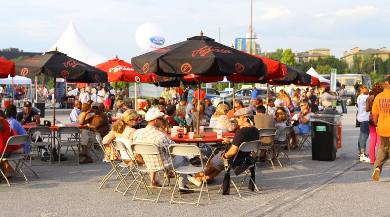 The Atlanta Bar-B-Q Festival occurs in the summer heat, but there’s plenty of shaded seating for crowds to enjoy their barbecue. This year’s event will be Aug. 14-15 at Atlantic Station. CONTRIBUTED BY TRAVIS HUDGONS