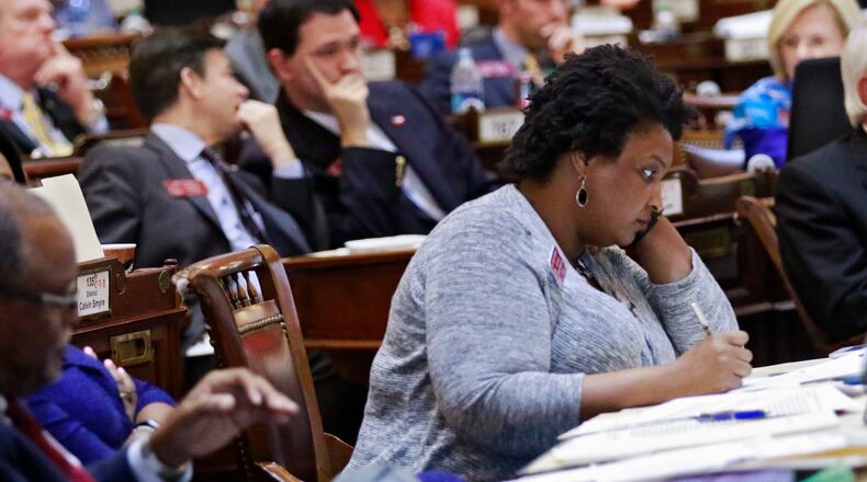 Mar. 16, 2016 - Atlanta - House Minority Leader Stacey Abrams, D - Atlanta, listens to debate on the bill. She later spoke in opposition to it. The House approved proposed changes to the controversial religious liberty bill. The new version cuts what opponents found most egregious about the earlier proposal, but still includes several passages they fear will allow legal discrimination. BOB ANDRES / BANDRES@AJC.COM