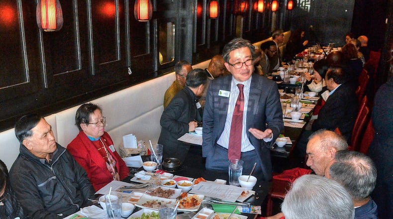 David Kim (standing), the son of South Korean immigrants, speaks with guests and supporters during a recent campaign luncheon. A Democrat, he is running in the 7th Congressional District rooted in Gwinnett and Forsyth counties. (Photo by Chris Hunt/Special)