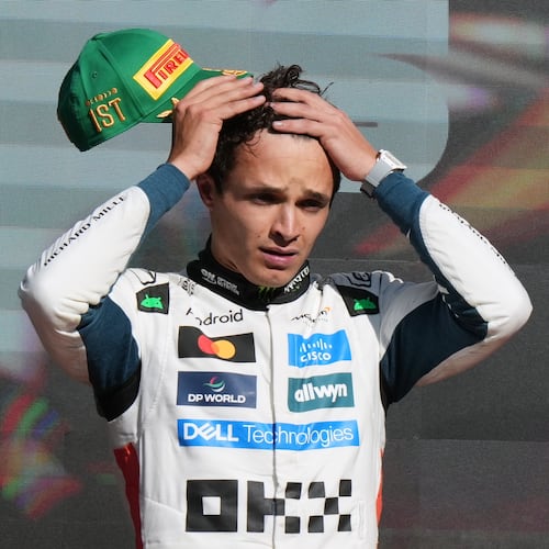 McLaren driver Lando Norris of Britain gestures on the podium after winning the Formula One Mexico Grand Prix in Mexico City, Sunday, Oct. 26, 2025. (AP Photo/Fernando Llano)