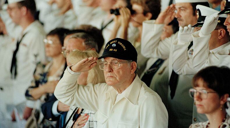 FILE - Pearl Harbor survivor Archie Odom, of Federal Way, Wash., salutes during a moment of silence in Pearl Harbor, Hawaii, Dec. 7, 1991, in remembrance of those killed during the Japanese attack on Pearl Harbor. Odom was a signalman on the bridge of the USS West Virginia when the Japanese attacked. (AP Photo/John Gaps III, File)
